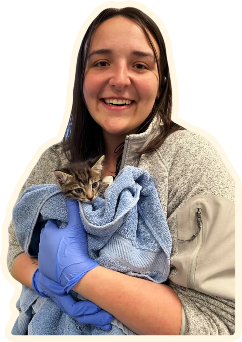 Elle holding a kitten wrapped in a towel