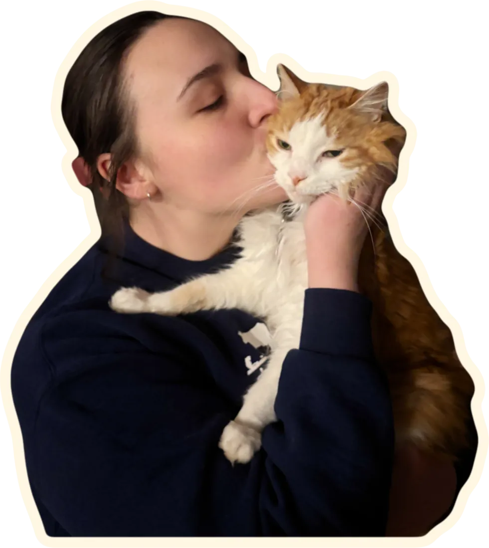 Elle kissing an orange and white cat