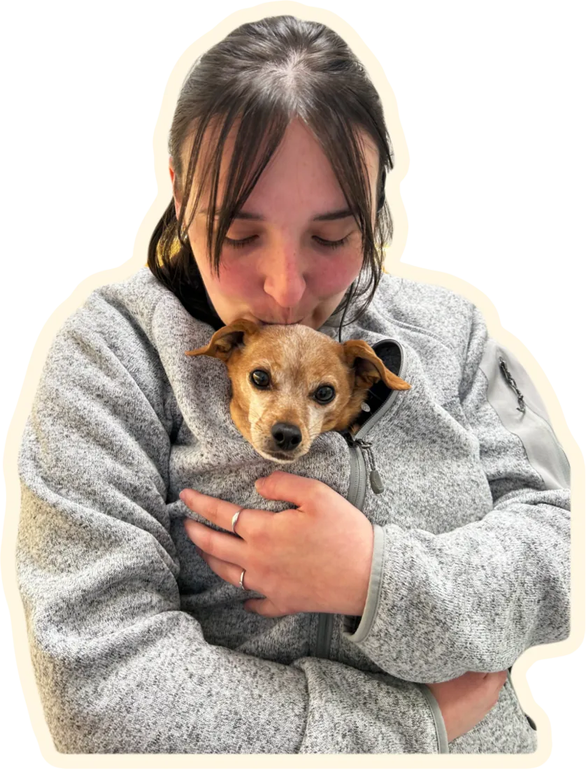 Elle hugging a small dog